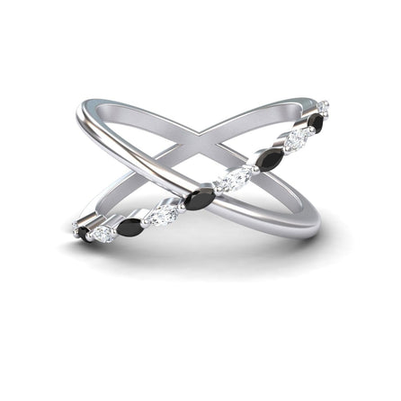 The Black & White Diamond Crossover Ring - Gracie features two intersecting silver bands, one plain and one set with alternating black and white diamonds, elegantly displayed on a white background.