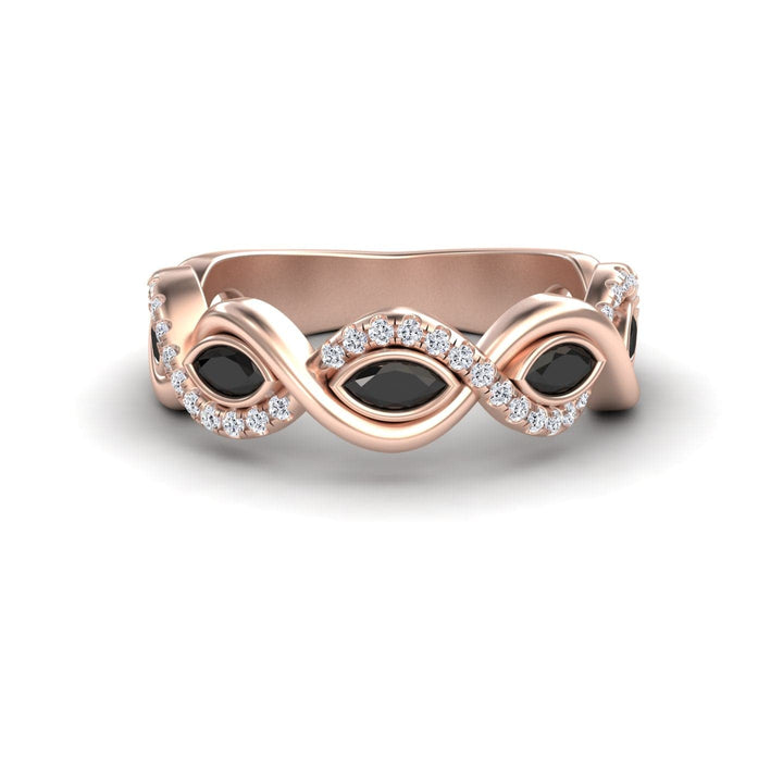 The Selma Black & White Diamond Infinity Twist Band features a rose gold infinity loop with three marquise black stones and white diamond accents, beautifully displayed on a white background.