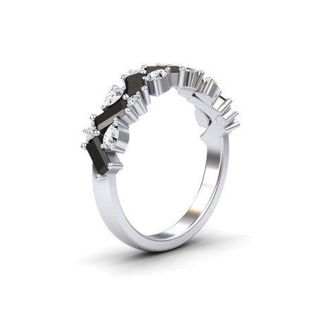 The Aimee Black & White Diamond Zigzag Eternity Band features alternating black and clear gemstones in a sleek zigzag pattern on a silver band, creating a modern, elegant look against a plain white background.