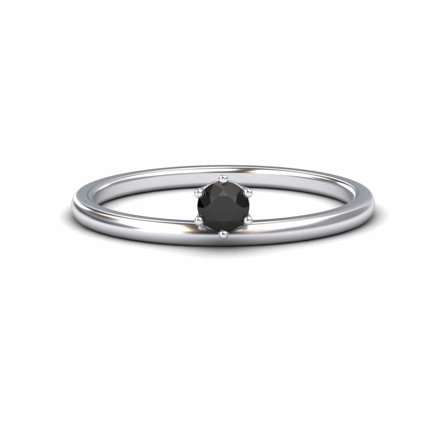The Black Diamond Solitaire Petite Ring - Faria features a single round black diamond held by six prongs in a simple silver band, shown against a plain white background.