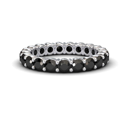 The Black Diamond Prong-Set Eternity Band - Mahira features round black stones set all around its silver band, shown against a white background.