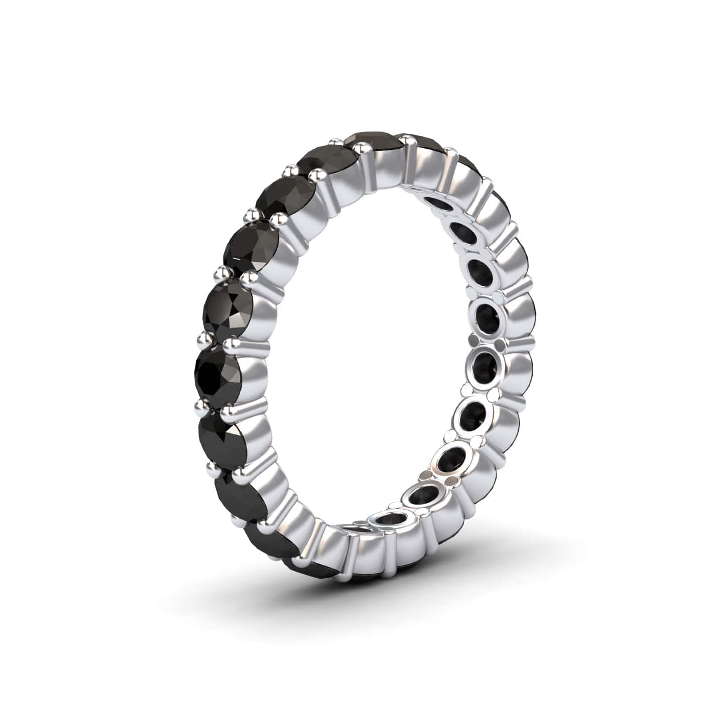 The Black Diamond Prong-Set Eternity Band - Mahira is a silver ring featuring a continuous row of round black diamonds in prong settings, shown against a white background.