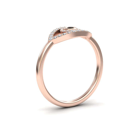 The Hazel Black & White Diamond Evil Eye Ring features a thin rose gold band and an evil eye setting adorned with black and white diamonds, displayed against a plain white background.