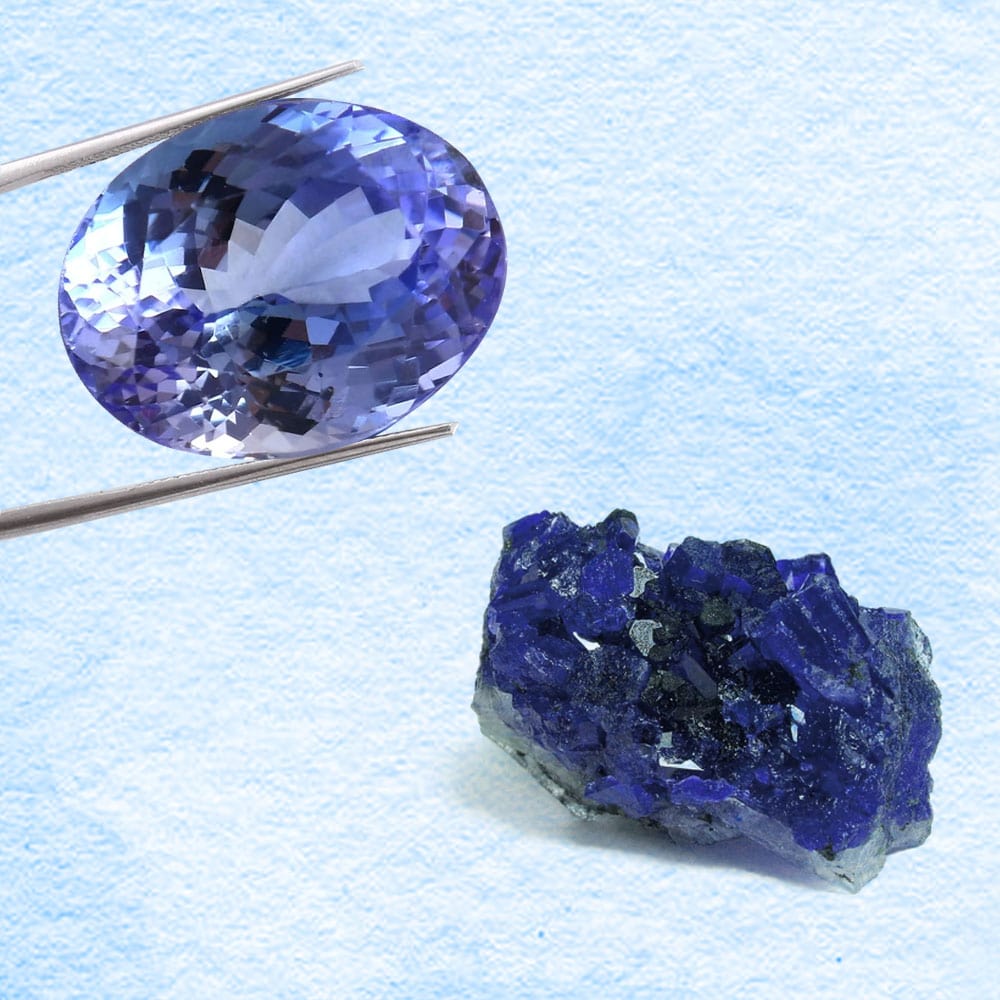 Cleavage of a purple tanzanite gemstone on a light blue background