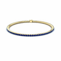 3.4-carat blue sapphire eternity bangle bracelet in 18K yellow gold, alejandra style, front view