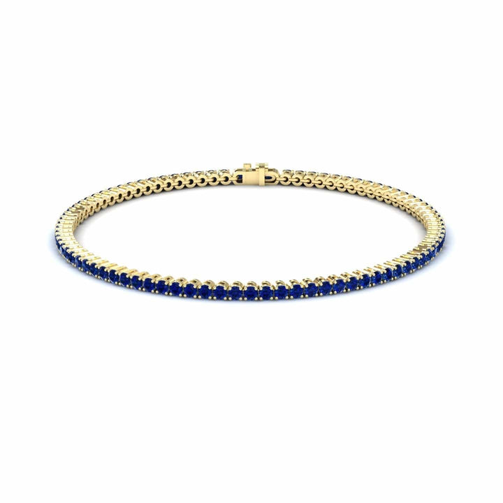3.4-carat blue sapphire eternity bangle bracelet in 18K yellow gold, alejandra style, front view