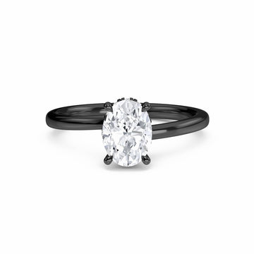 The White Diamond Hidden Halo Solitaire Engagement Ring - Lyric features a 0.20 ct oval E/VS1 diamond in a four-prong 18K blackened gold setting, shown on a white background.