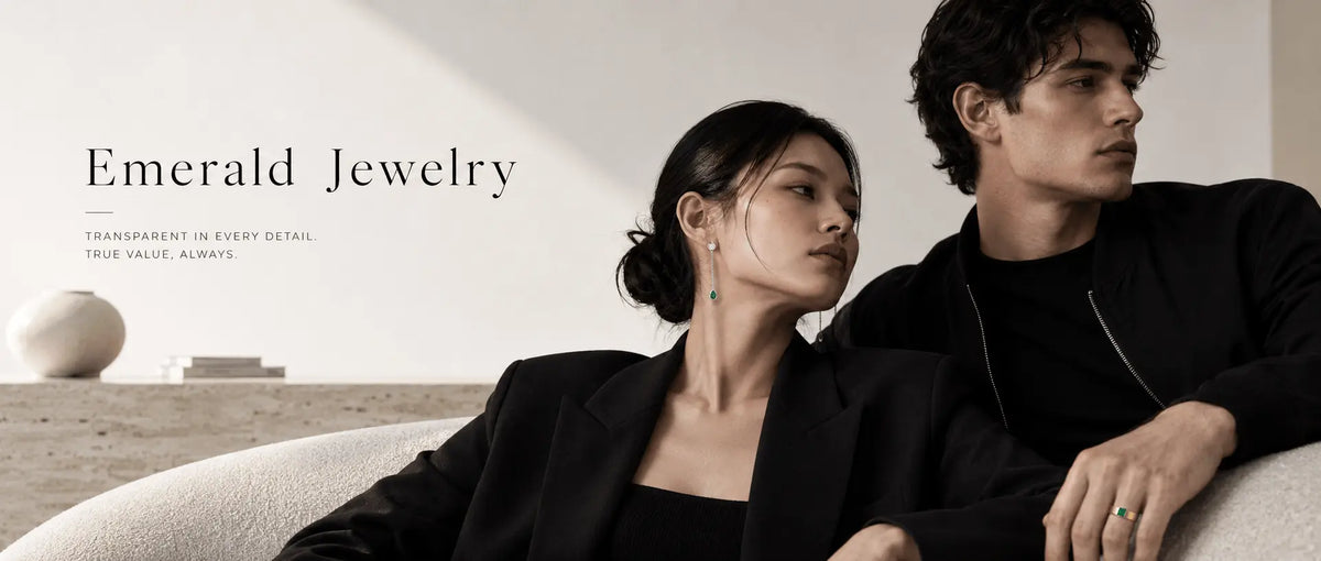 Young couple seating on couch wearing Emerald Jewelry