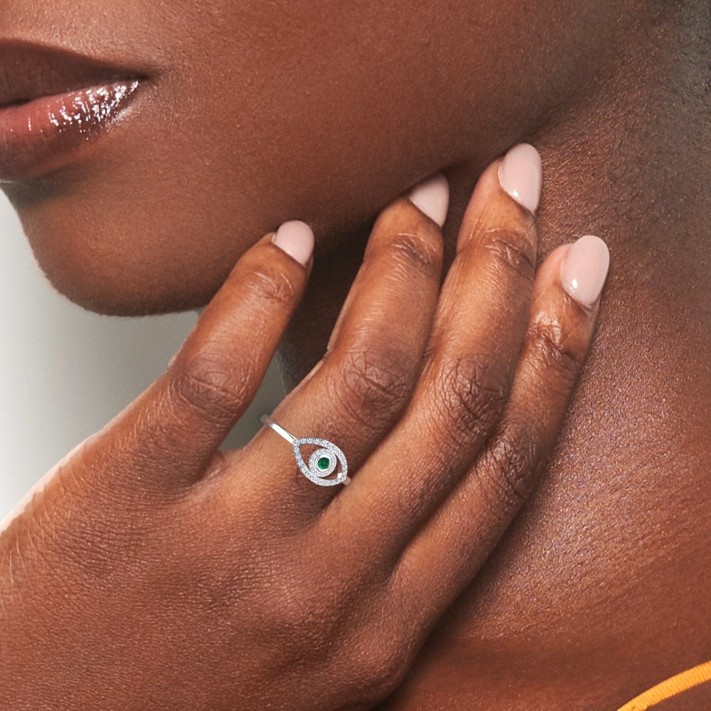 0.04 carat Emerald & Diamond Evil Eye Ring in 14K White gold, hazel style, hand view