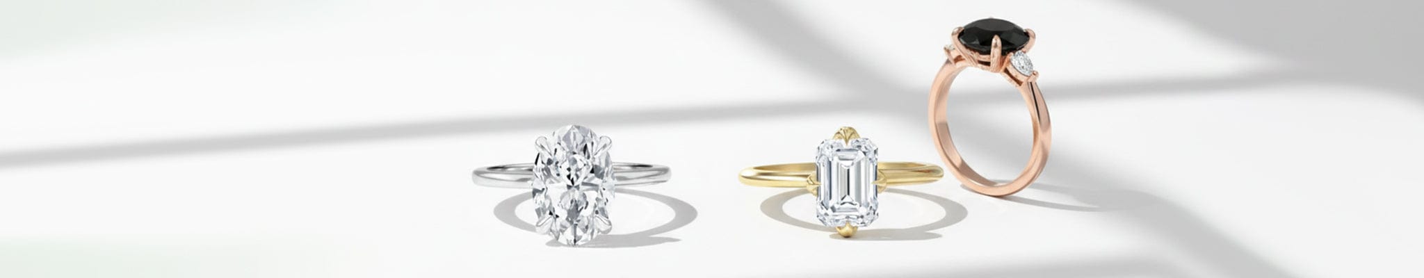 Three diamond rings in different designs on a white background