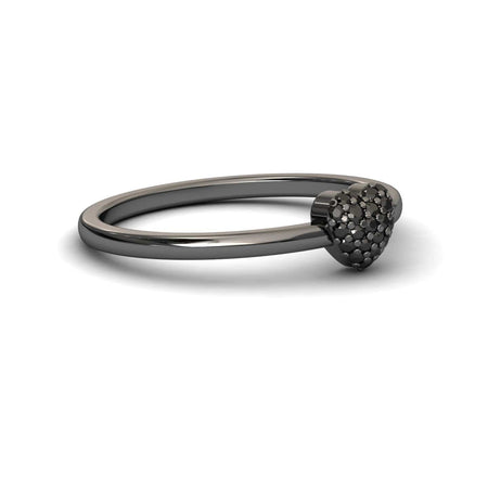 The Black Diamond Pave Heart Ring - Bonita is a sleek black metal ring with a small, textured heart adorned with sparkling pave stones on top, shown against a white background.